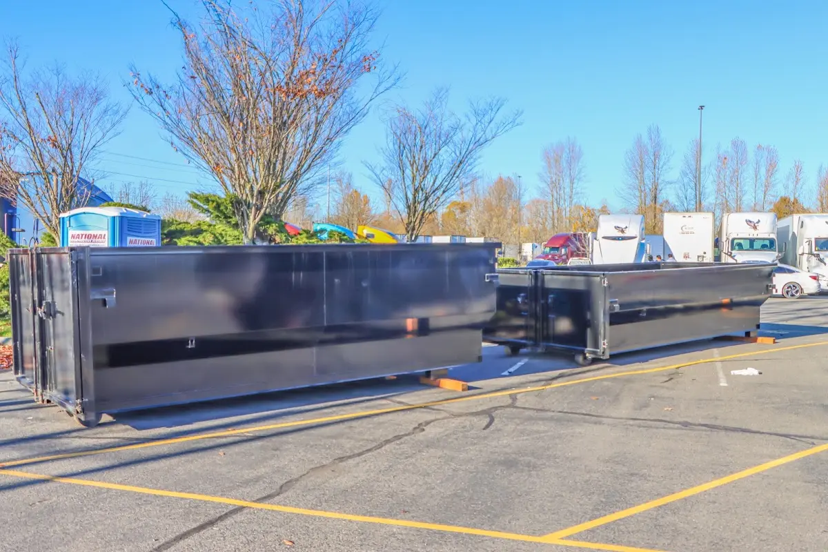 Professional dumpster rental service with roll-off container on residential driveway in Coachella